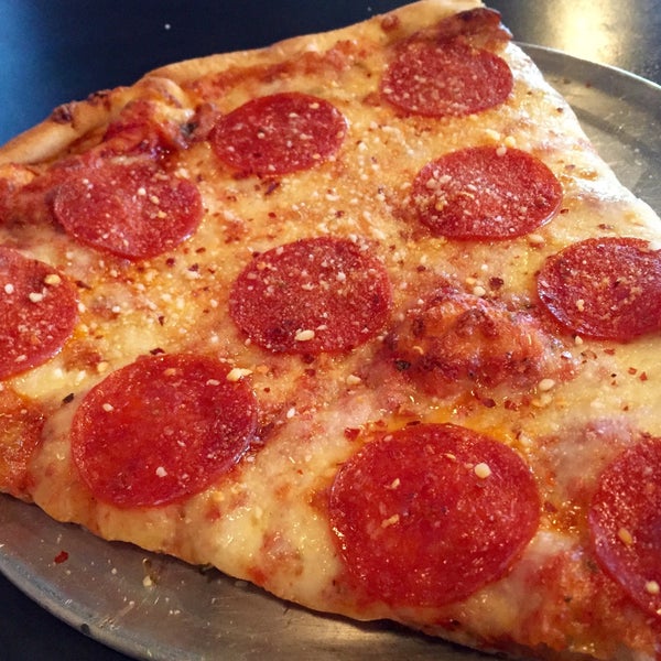 a close up of a pepperoni pizza sitting on top of a pan