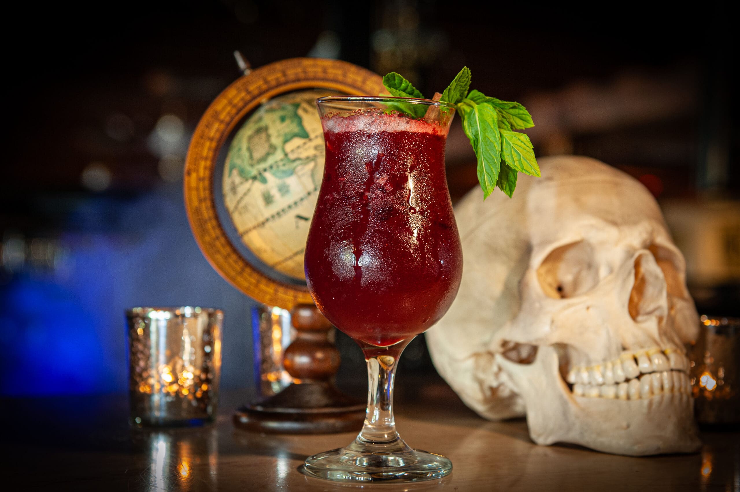 a glass of wine sitting on top of a table