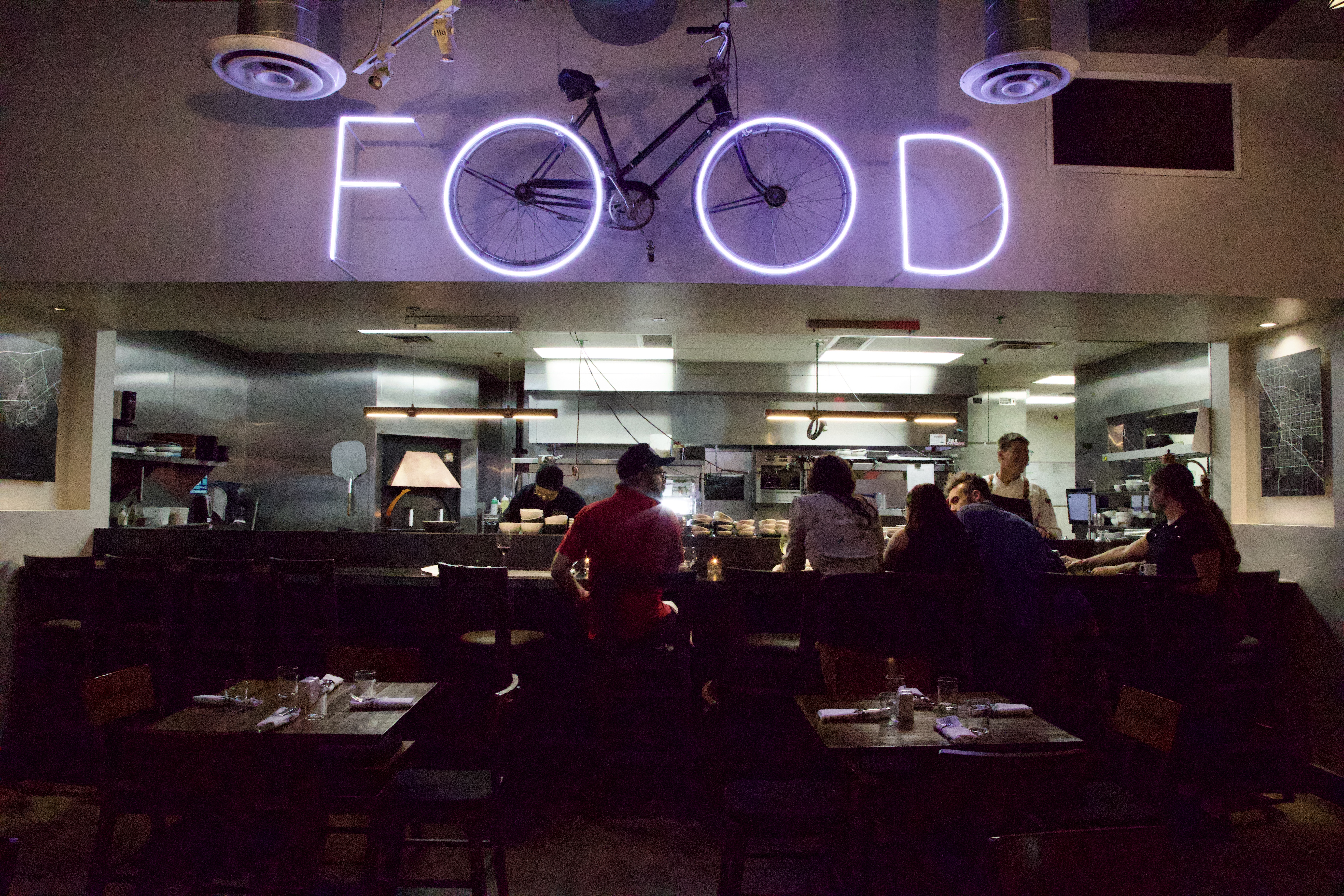 a group of people sitting at a table in a restaurant