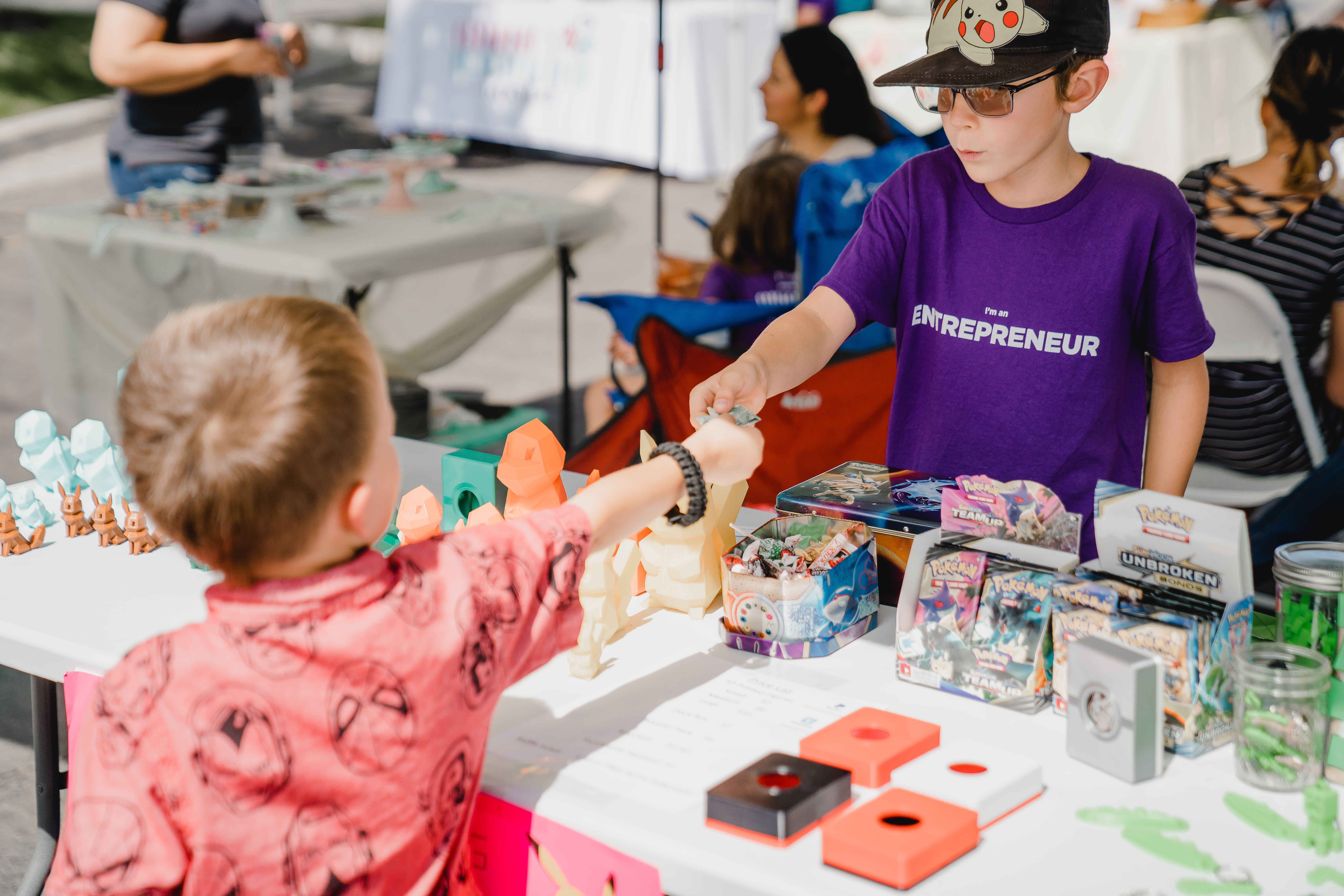 a little boy sitting at a table with a birthday cake