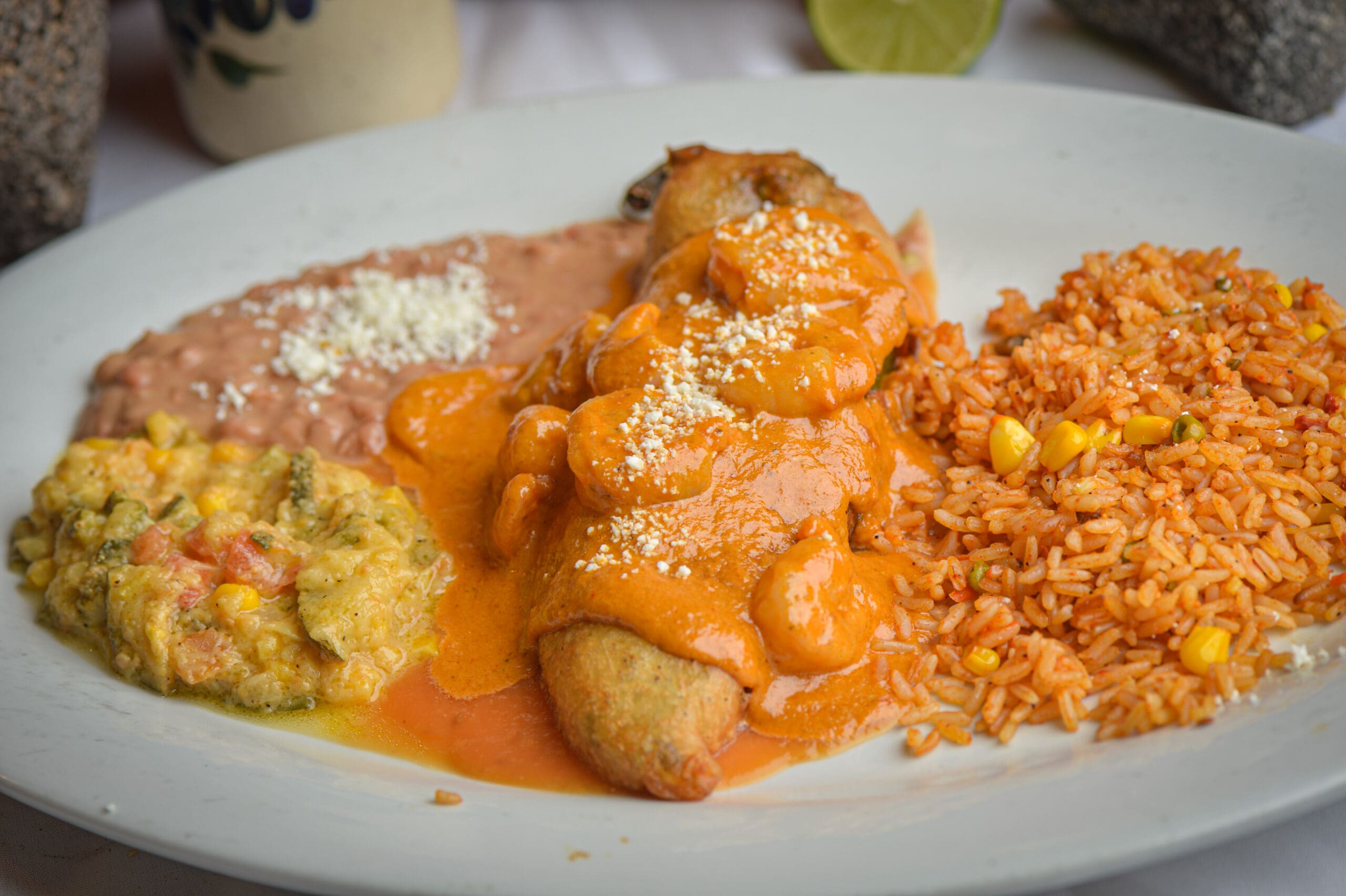 a plate of food with rice meat and vegetables
