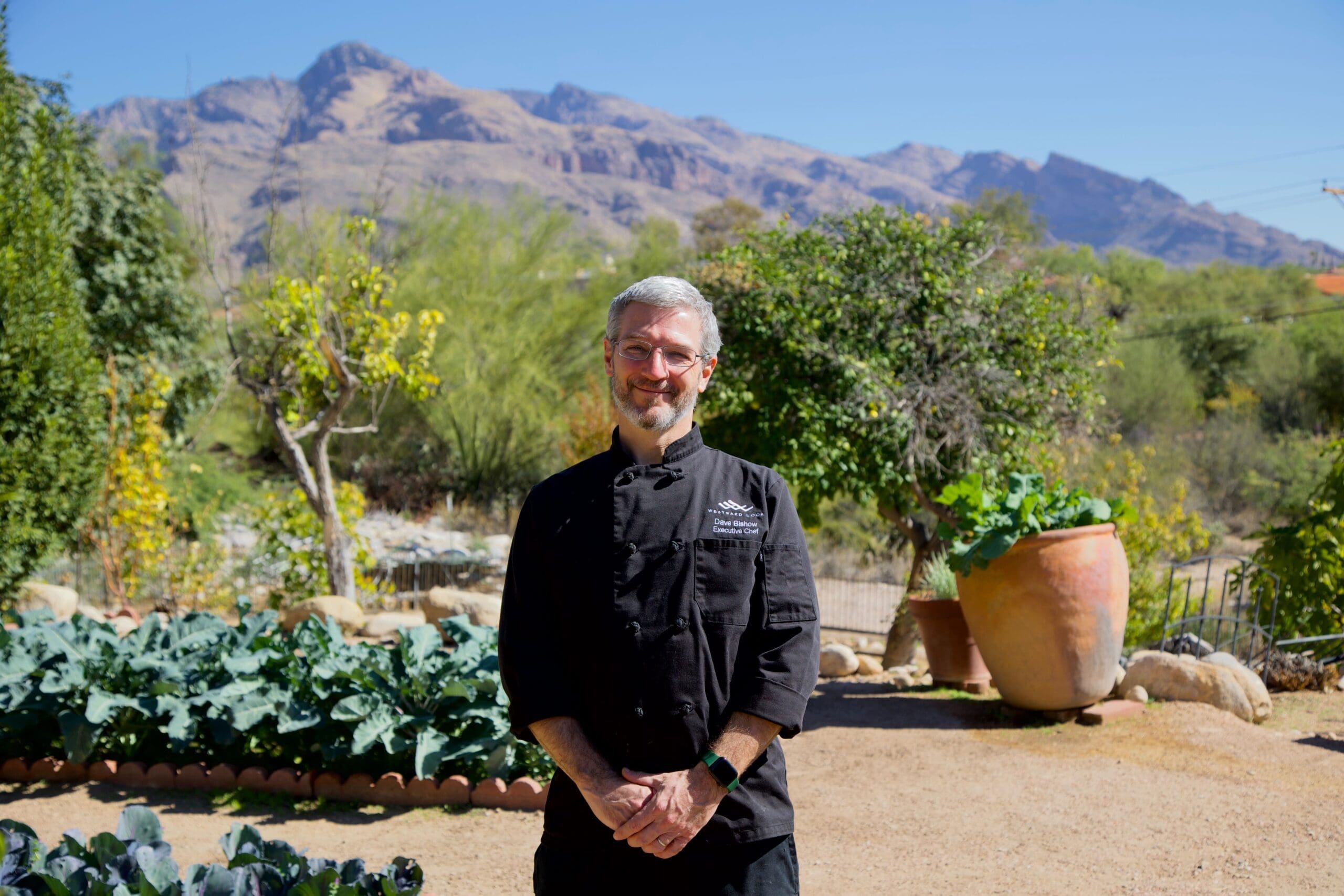 a man standing in front of a mountain