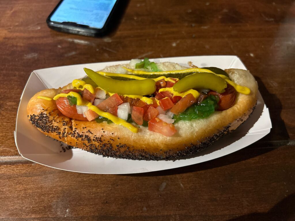 a plate with a hot dog sitting on a table