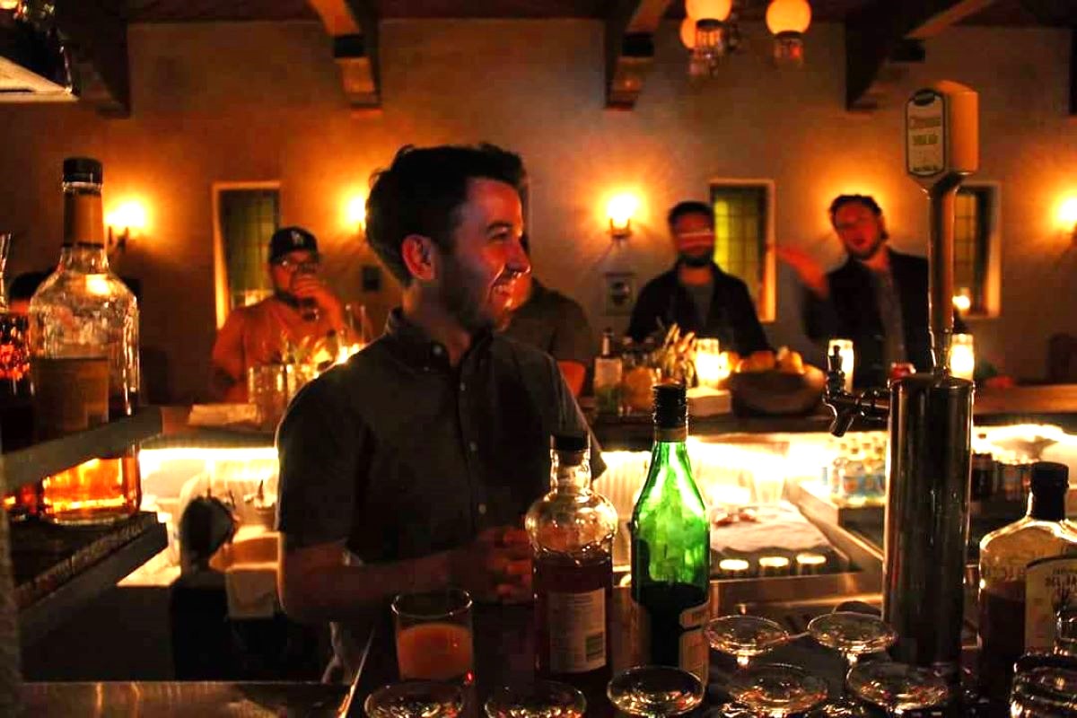 a person sitting at a table with wine glasses