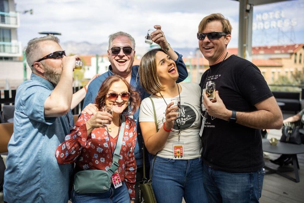 a group of people standing together smiling for the camera