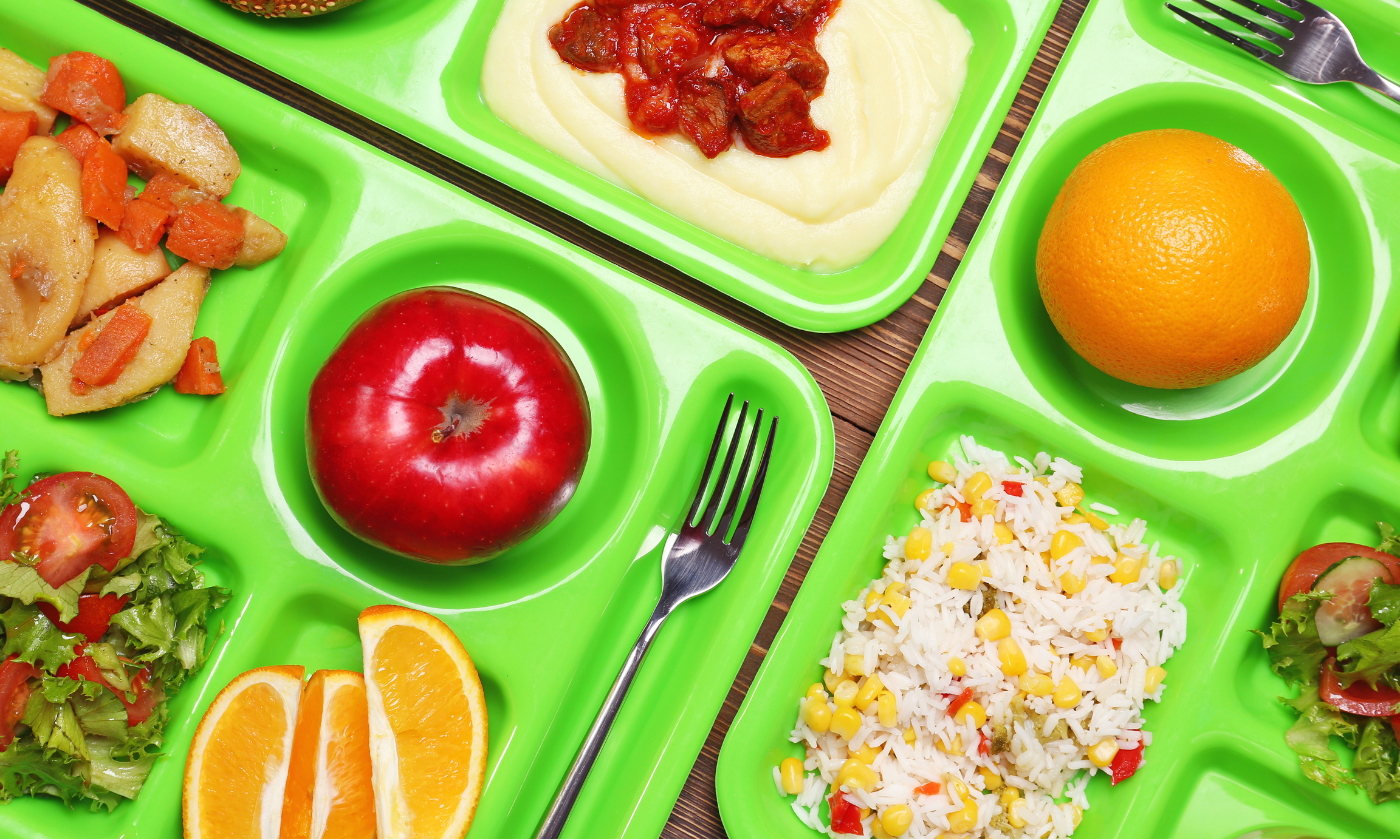 a plastic container filled with different types of food on a plate