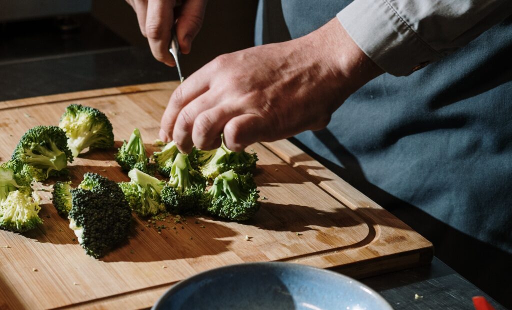 a wooden cutting board with broccoli