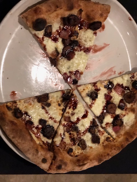 a close up of a slice of pizza on a plate