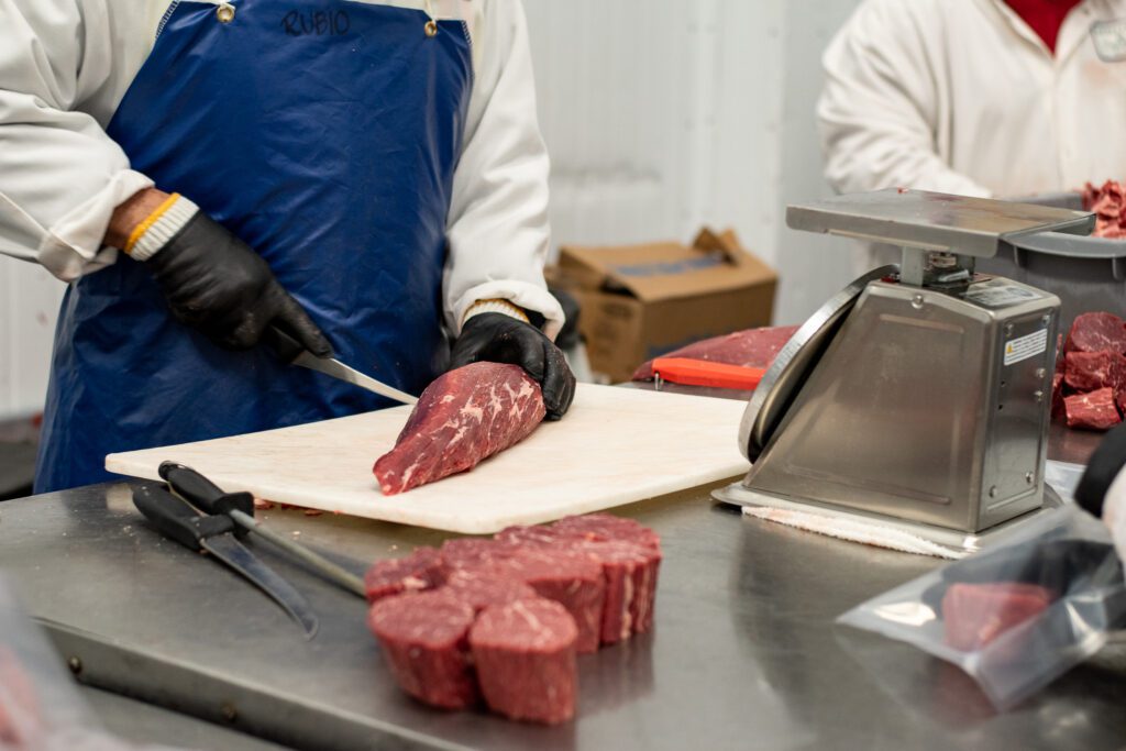 Meat cutting at Merit Foods of Arizona (Photo by Jackie Tran)