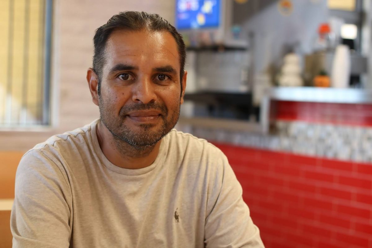 Eleazar Beltran smiles inside his restaurant, Paco’s Mexican Food (Photo by Noor Haghighi)