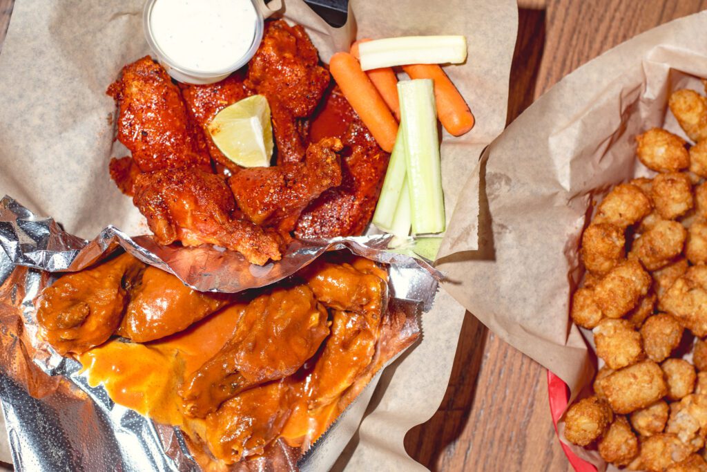 Gold Heat wings, Hot Limon wings, and tots at Wings y Más (Photo by Jackie Tran)