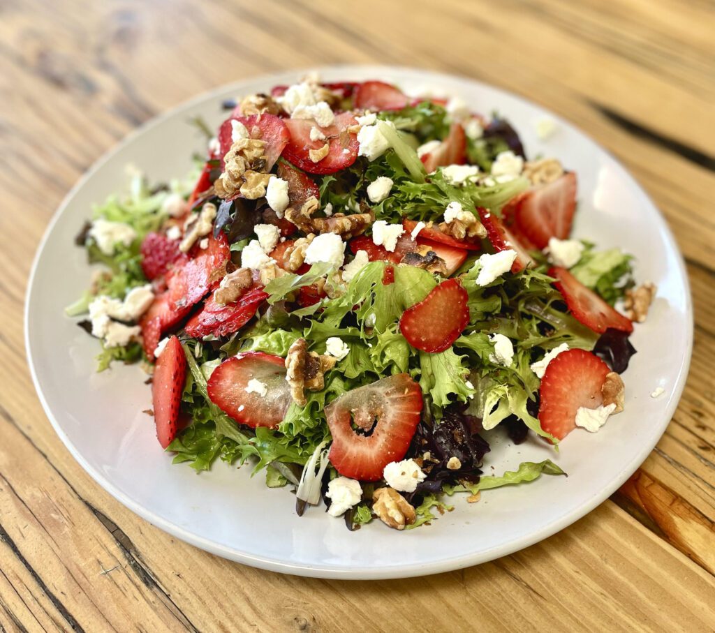 Strawberry, Goat Cheese, & Toasted Walnut Salad with Lemon Balsamic Dressing (Photo courtesy of Ghini's French Caffe)