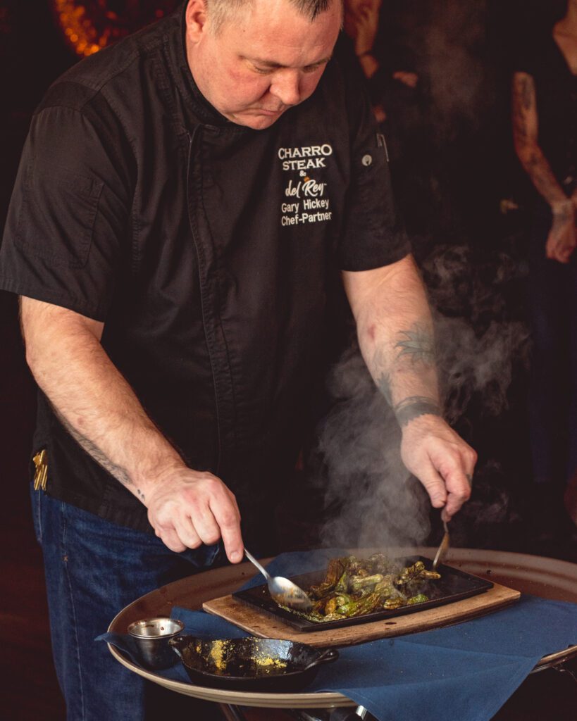 Chef Gary Hickey preparing Chiles al Fuego at Charro Steak North (Photo by Jackie Tran)